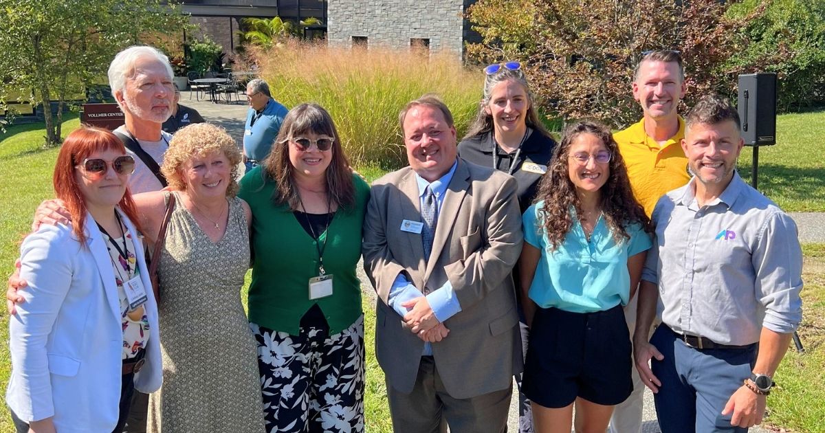 Group photo of representatives from AP Corp, Baltimore City, and Decorative Films celebrating the successful bird safety window film installation at Cylburn Arboretum