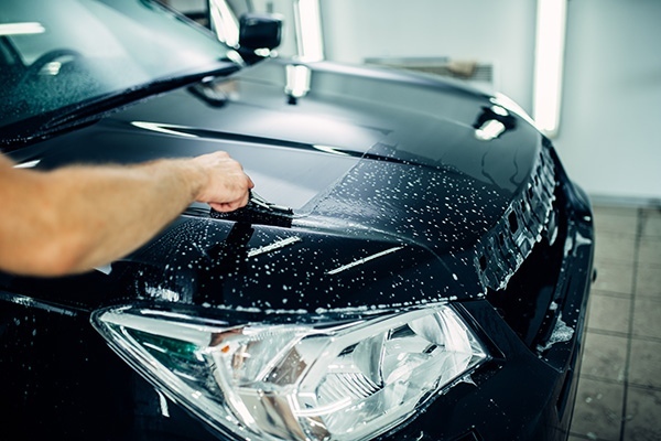 Technician installing paint protection film