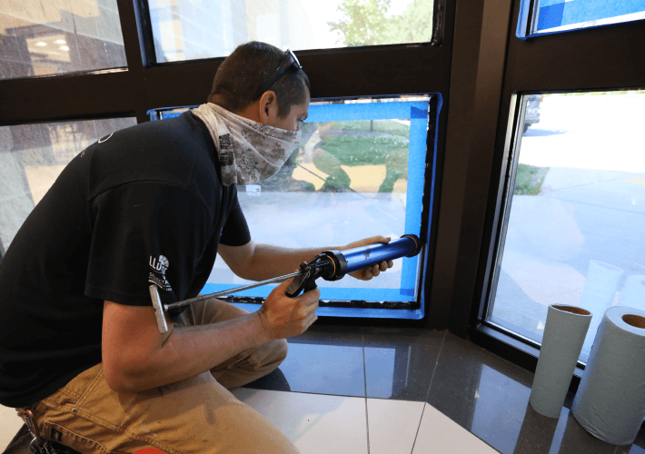 ban installing security window film wearing bandana