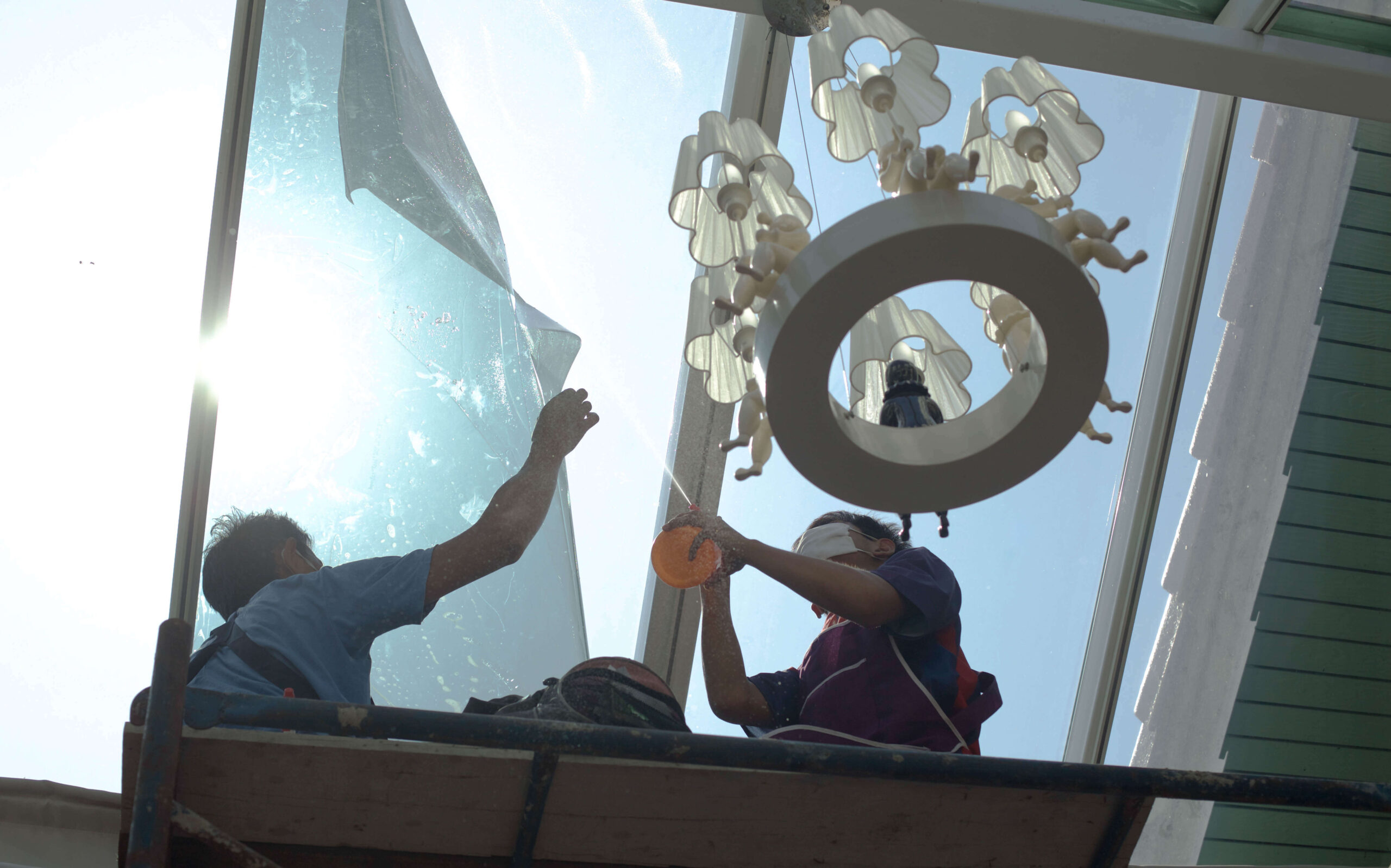 men installing anti dog window film in restaurant