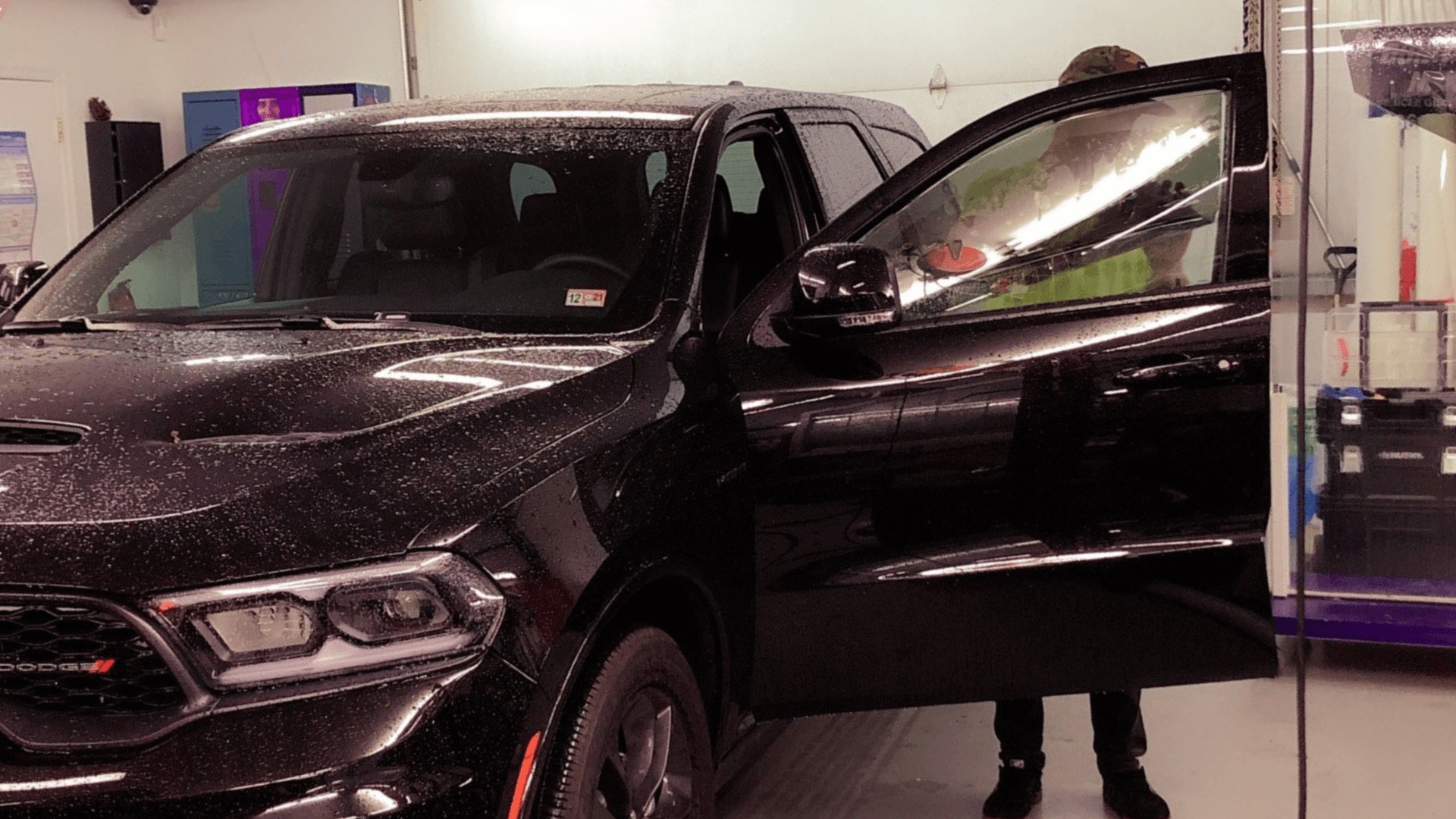 man tinting black truck