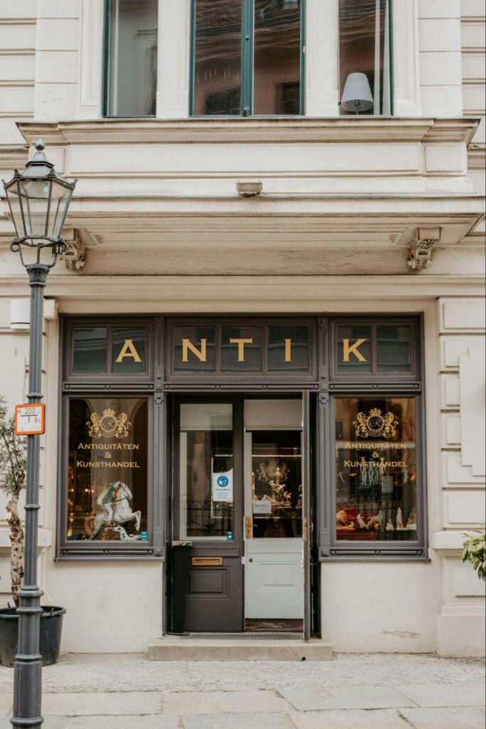 A storefront featuring ornate golden graphics adhered to the windows.