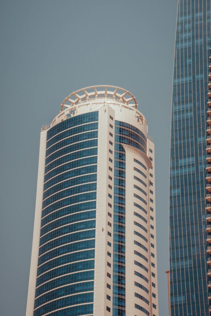 A white high rise building with tinted windows.