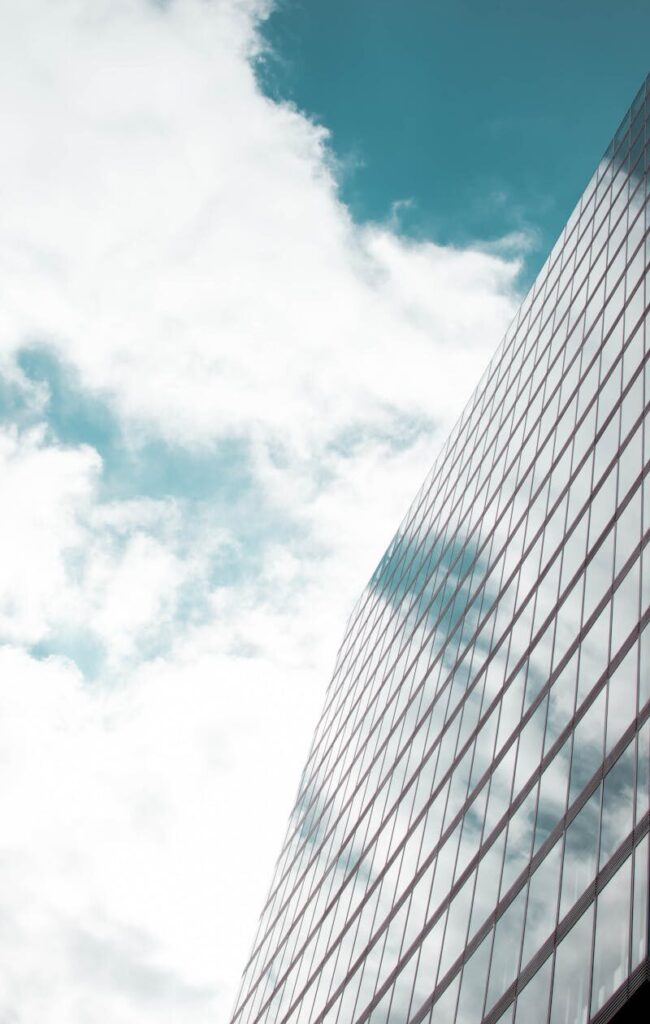 Exterior of a tall office building against a cloudy sky