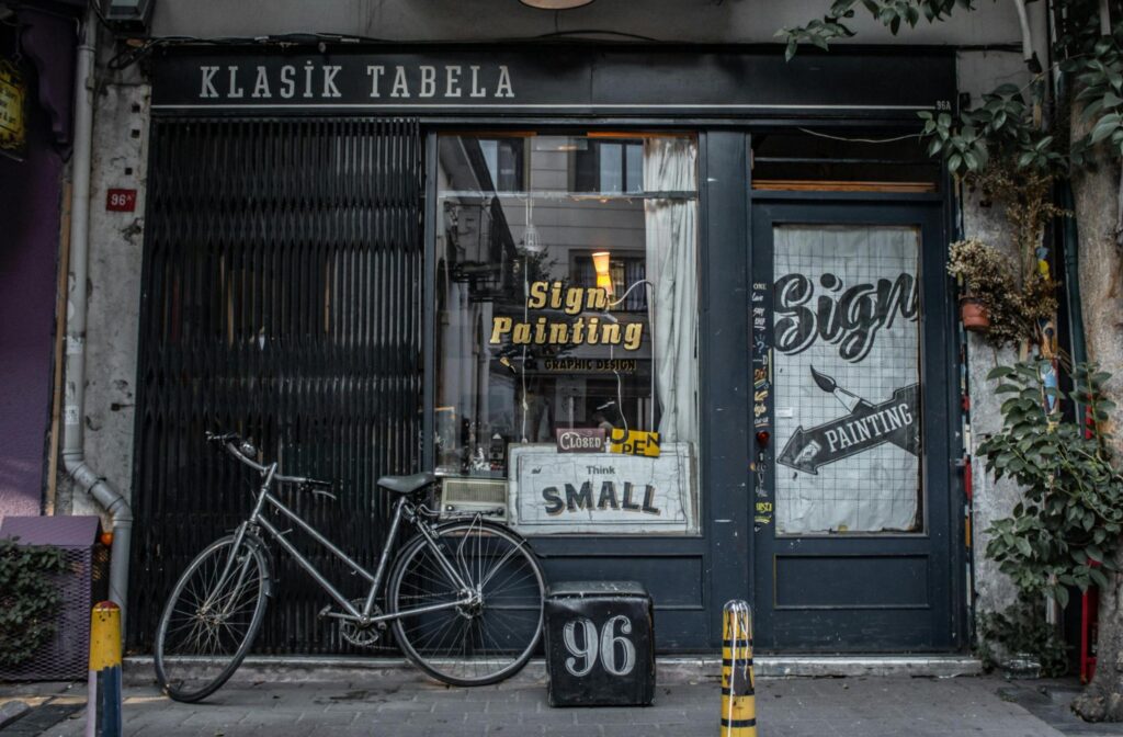 A storefront with custom-created window film advertising sign painting.