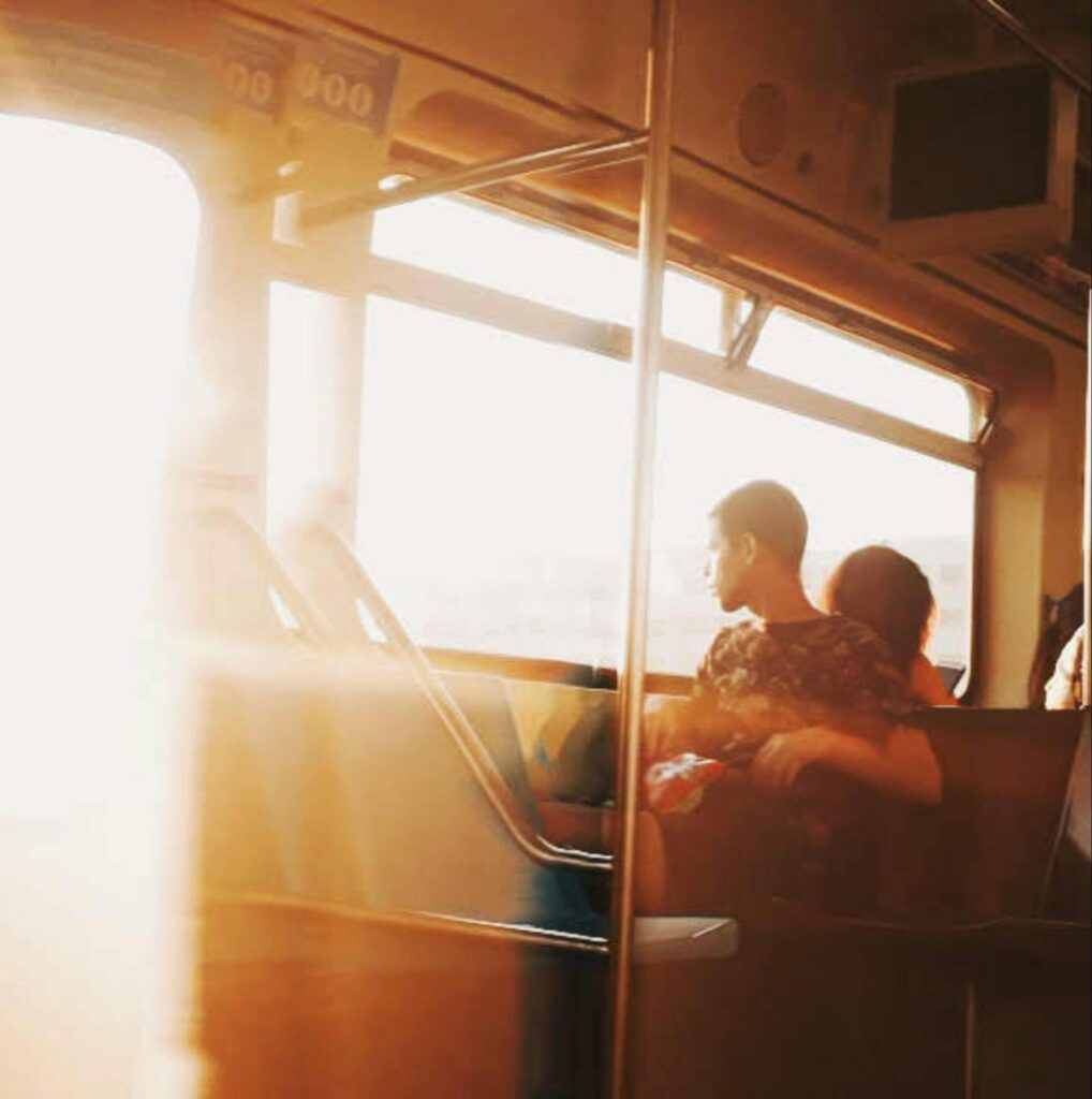 Man Looking Outside of a Bus Window