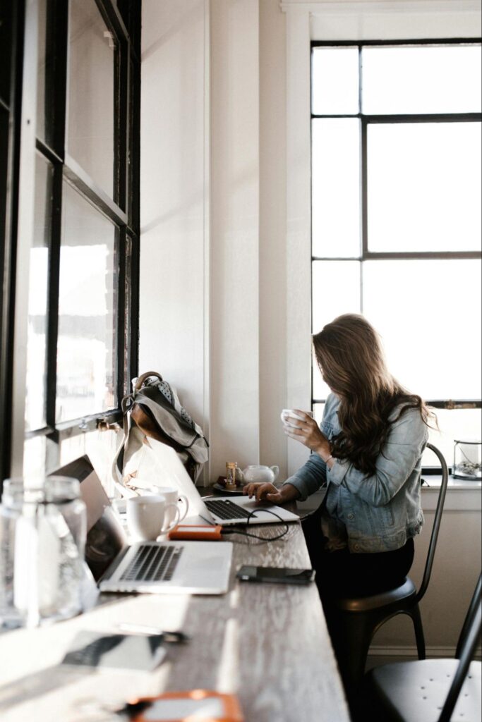 Woman Working at Computer with Tea
