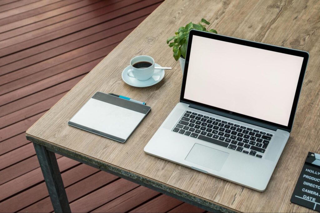 Table with Tablet, Laptop, and Coffee