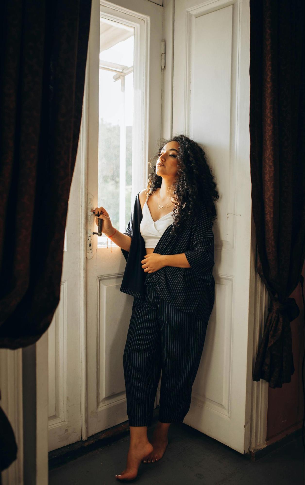 Woman Standing Barefoot at the Door