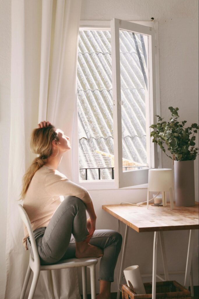 Woman Sitting by an Open Window