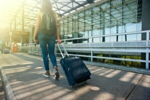 Woman Walking with Luggage at the Airport