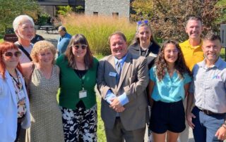 Group photo of representatives from AP Corp, Baltimore City, and Decorative Films celebrating the successful bird safety window film installation at Cylburn Arboretum