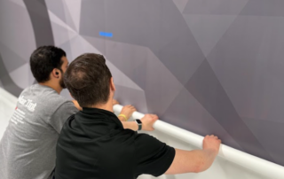 Solar Tint team installing custom wayfinding wall graphics.