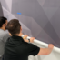 Solar Tint team installing custom wayfinding wall graphics.